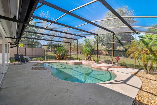 pool with glass enclosure and a patio area