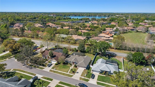 bird's eye view featuring a residential view, a view of trees, and a water view