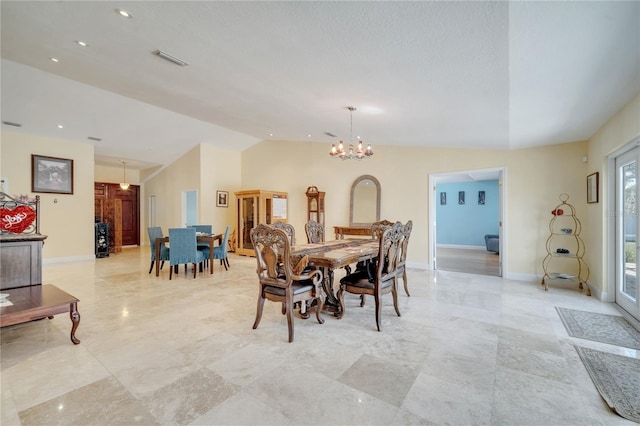 dining space with a chandelier, lofted ceiling, visible vents, and baseboards