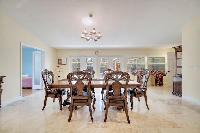 dining area with french doors, a notable chandelier, marble finish floor, and baseboards