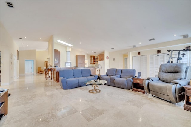 living area featuring marble finish floor, visible vents, and recessed lighting