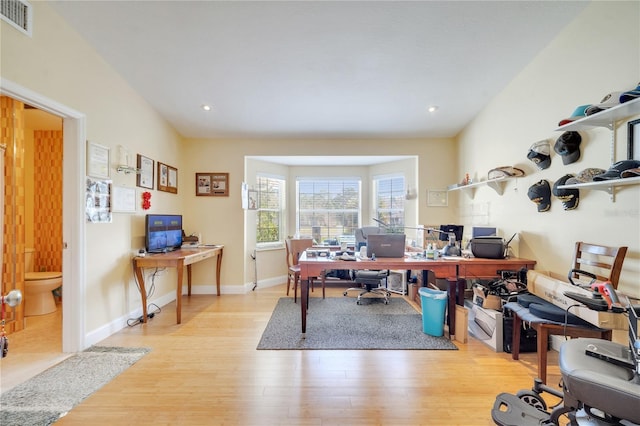 home office with recessed lighting, wood finished floors, visible vents, and baseboards