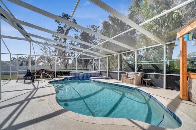 view of pool with a lanai, fence, and a patio