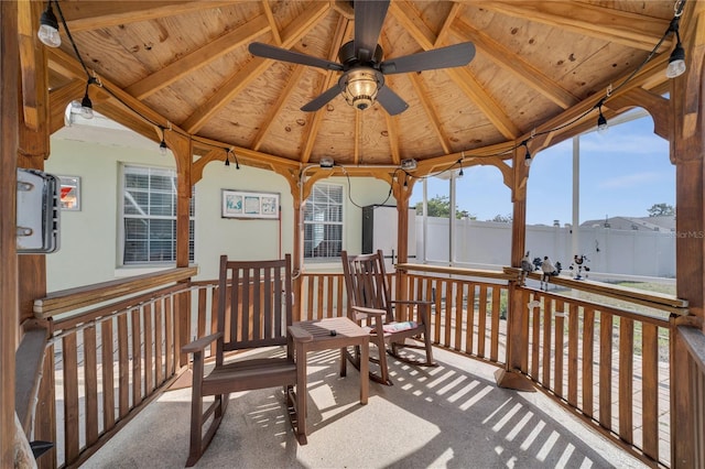 wooden terrace featuring a gazebo, fence, and a ceiling fan