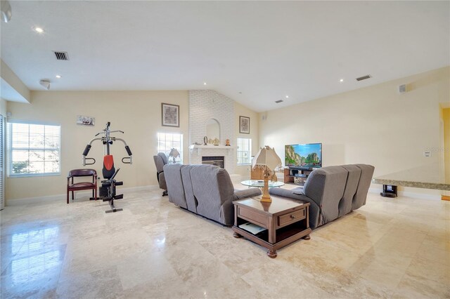 living area with lofted ceiling, a brick fireplace, visible vents, and baseboards