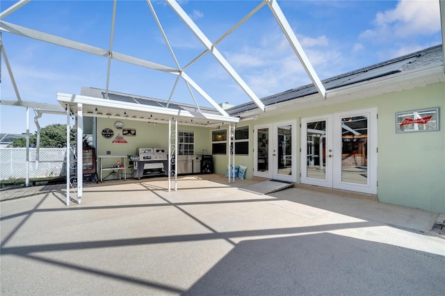 exterior space featuring glass enclosure and french doors