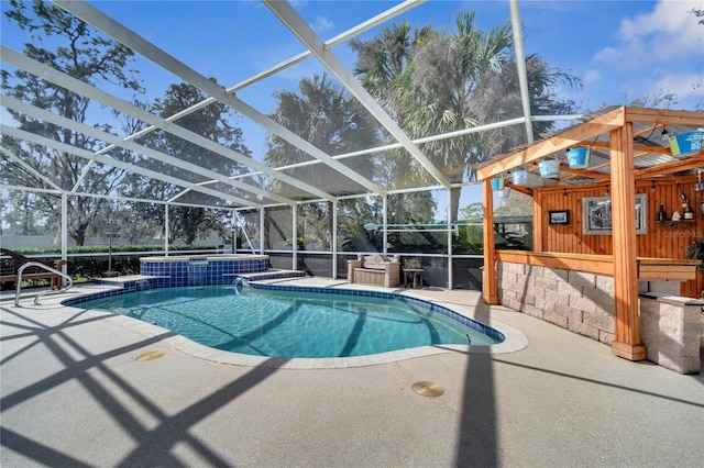 outdoor pool with glass enclosure and a patio area