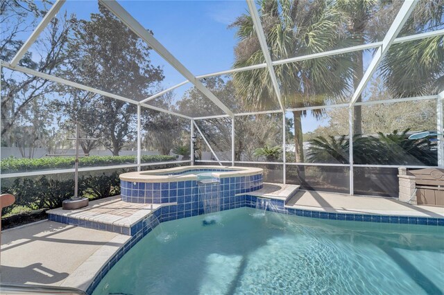 outdoor pool with a lanai, a patio, and an in ground hot tub