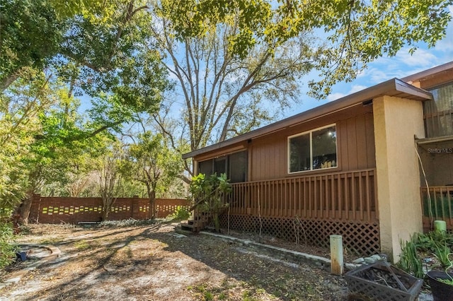 view of side of property featuring fence