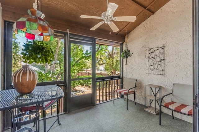 sunroom / solarium with vaulted ceiling and a ceiling fan