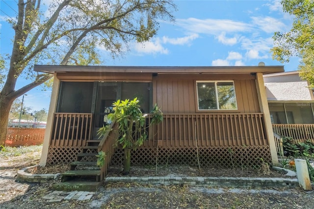 exterior space with a sunroom and a deck