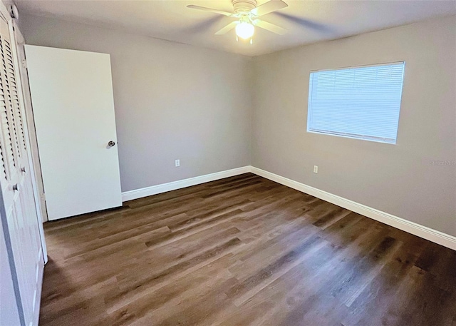 unfurnished bedroom featuring dark wood finished floors, ceiling fan, and baseboards