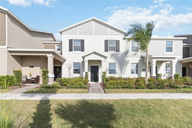 view of front of house with a front lawn and stucco siding