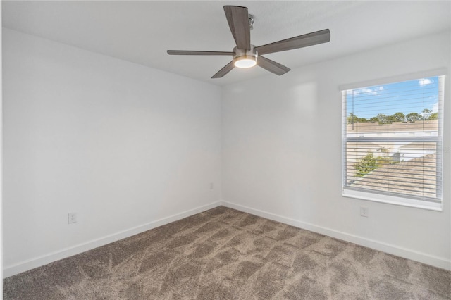 empty room featuring carpet flooring, baseboards, and ceiling fan