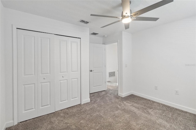 unfurnished bedroom with a closet, visible vents, and carpet