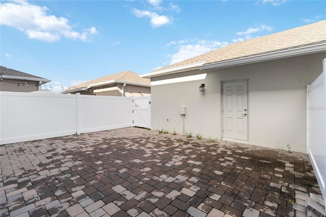 view of patio with a gate and fence