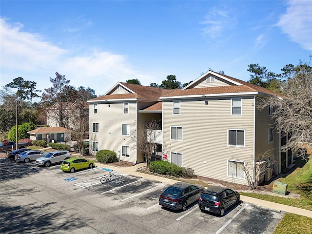 view of property featuring uncovered parking