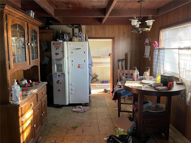 kitchen featuring wooden walls, an inviting chandelier, beam ceiling, wood ceiling, and white fridge with ice dispenser