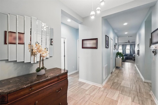 hall featuring recessed lighting, visible vents, and baseboards