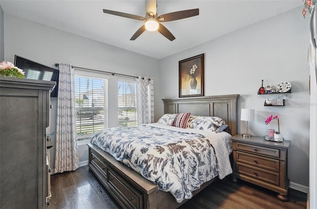 bedroom featuring baseboards, dark wood-style flooring, and ceiling fan