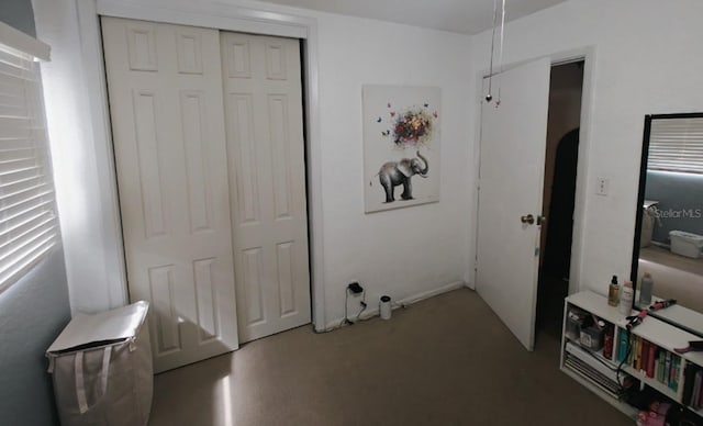 bedroom featuring concrete floors