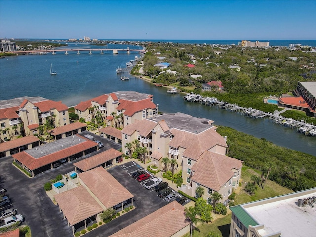 drone / aerial view featuring a water view and a residential view