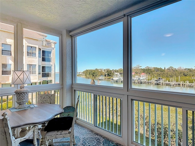 sunroom / solarium with a water view