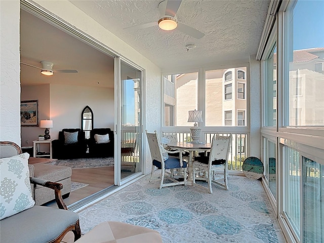 sunroom featuring a ceiling fan