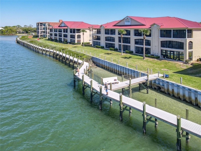 view of dock featuring a yard and a water view