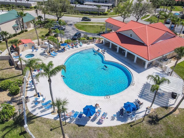 community pool featuring a patio area and fence