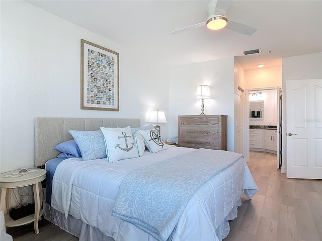 434 Bouchelle Dr Unit 202, New Smyrna Beach, FL 32169 - bedroom with light wood-style floors, ensuite bathroom, and a ceiling fan