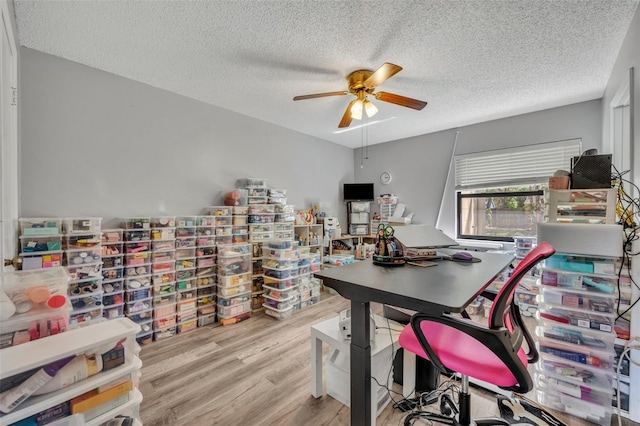 office space featuring a textured ceiling, ceiling fan, and wood finished floors