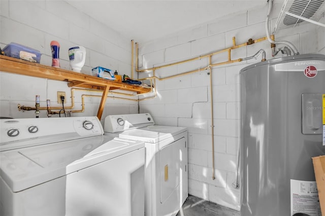 clothes washing area with laundry area, independent washer and dryer, electric water heater, and concrete block wall