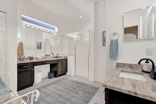 bathroom featuring a sink, two vanities, a shower stall, and tile patterned floors