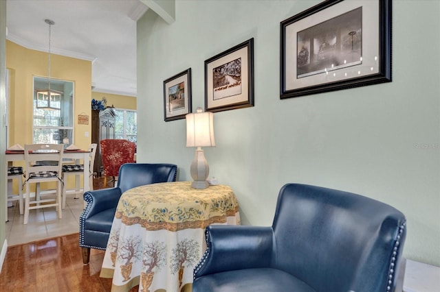 sitting room with crown molding and wood finished floors