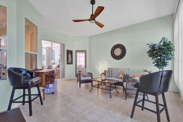 tiled living room featuring ceiling fan