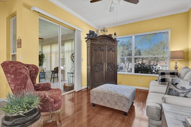 interior space with a healthy amount of sunlight, wood finished floors, and crown molding