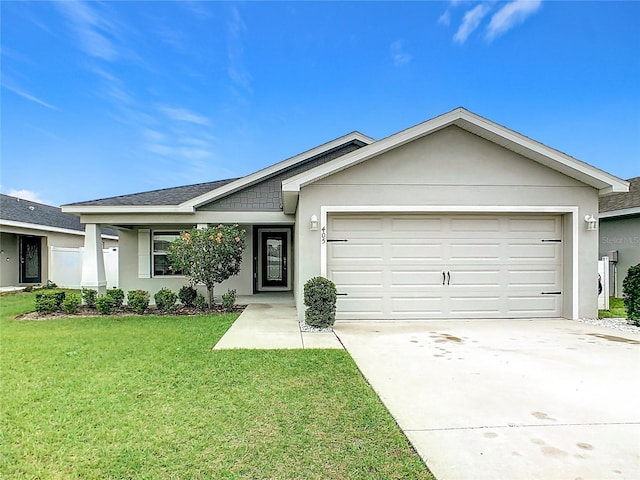 ranch-style home with a front yard, an attached garage, concrete driveway, and stucco siding