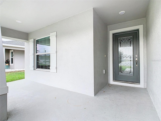 entrance to property with stucco siding