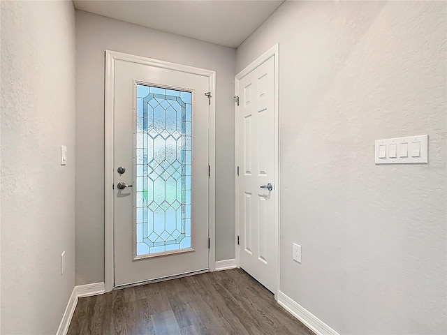 entrance foyer featuring baseboards and dark wood-style floors