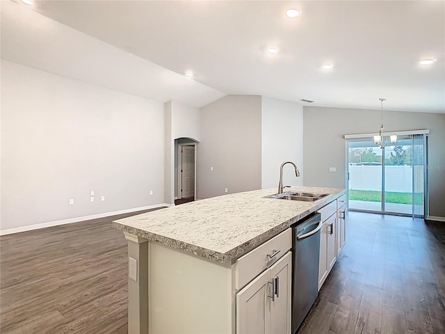 kitchen with lofted ceiling, arched walkways, a kitchen island with sink, a sink, and dishwasher