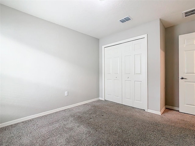 unfurnished bedroom with visible vents, baseboards, and carpet