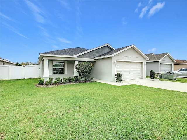 view of front of home with a front yard, fence, driveway, an attached garage, and stucco siding