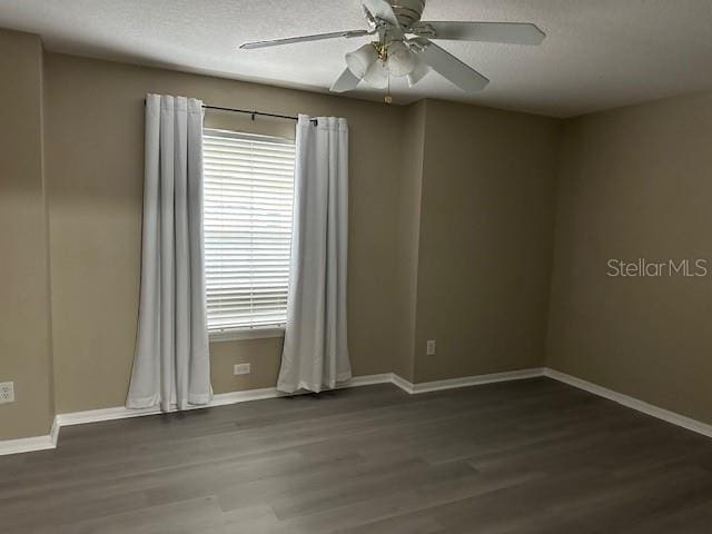 empty room with a healthy amount of sunlight, ceiling fan, a textured ceiling, and wood finished floors