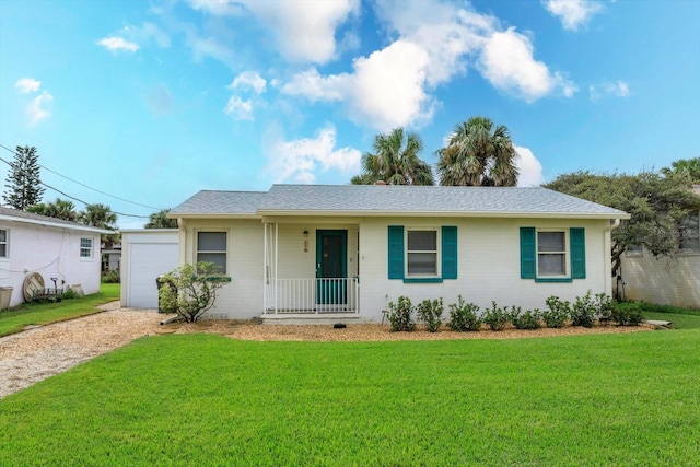 ranch-style home featuring a porch, driveway, a shingled roof, and a front yard