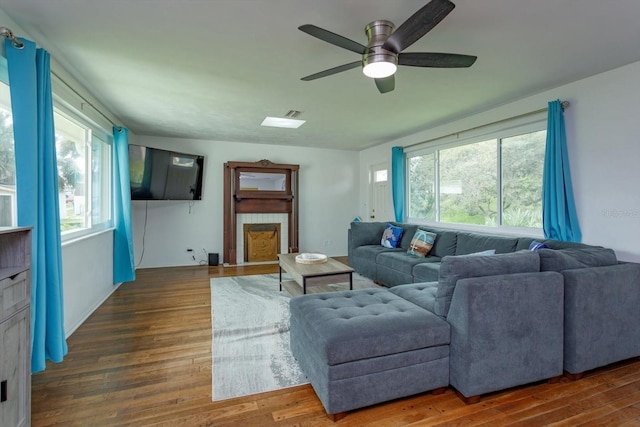 living room featuring ceiling fan and wood finished floors