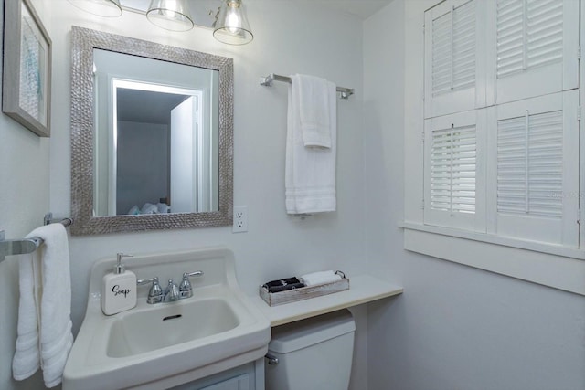 bathroom with toilet and a sink