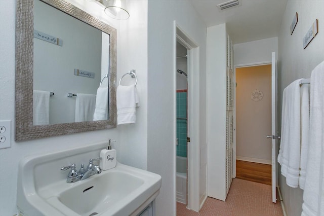 full bath with a sink, visible vents, and shower / bath combination