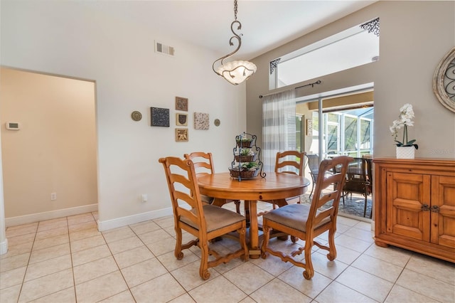 dining room featuring light tile patterned floors, baseboards, and visible vents