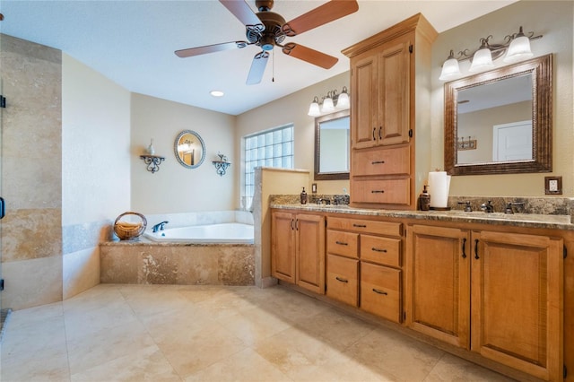 bathroom featuring tile patterned flooring, double vanity, a bath, a ceiling fan, and a sink